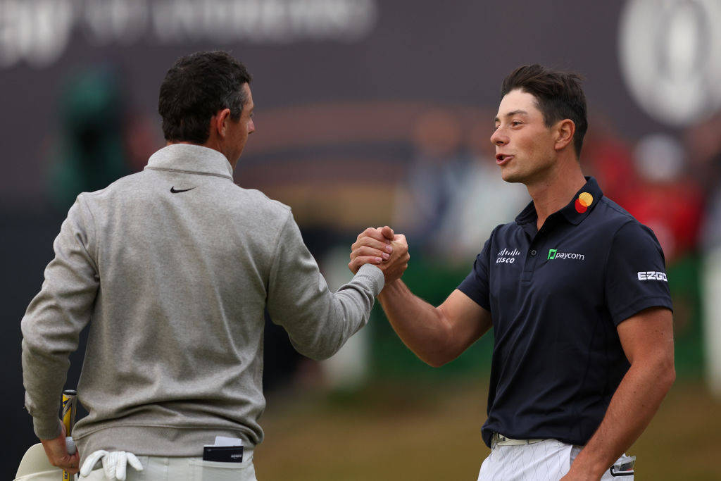 Rory McIlroy and Viktor Hovland shake hands at the end of their third rounds in The 150th Open
